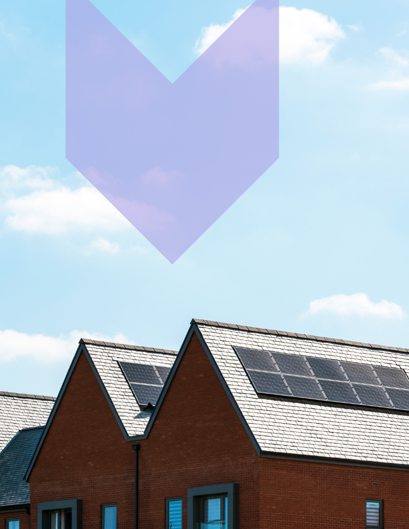 Houses with pitched roofs in a row with a clear sky background. Solar panels on all roofs. IXT brand graphic as arrow pointing down on the solar panels. 